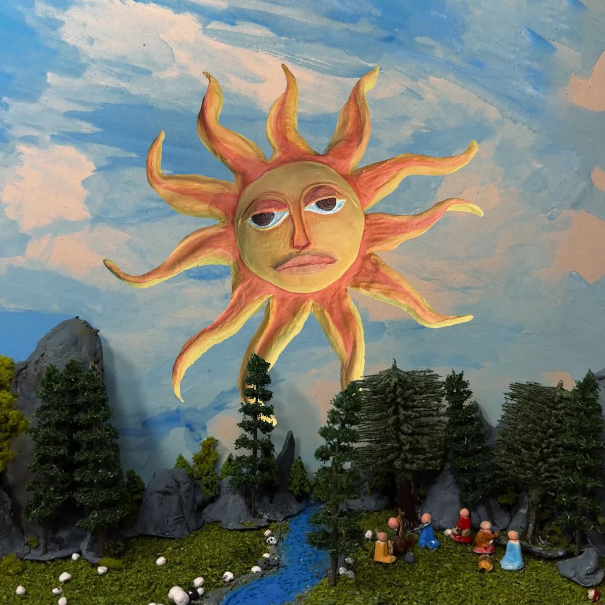 Arte de portada de Siddhartha con un sol pintado sobre un paisaje en miniatura