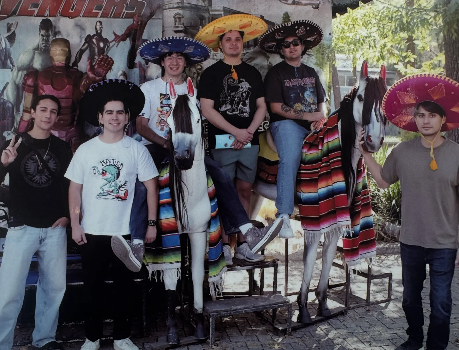 Vertigo members posing outdoors with friends and costumed performers
